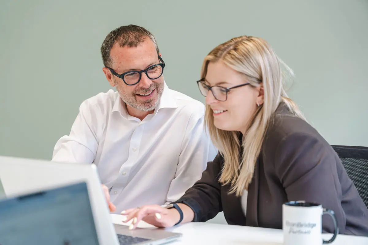 Man and woman in meeting - Eton Bridge Partners