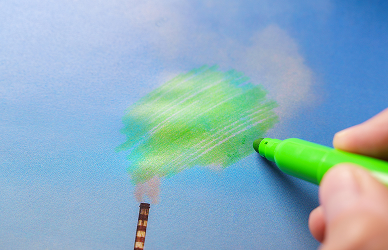 Man painting green pollution from a chimney