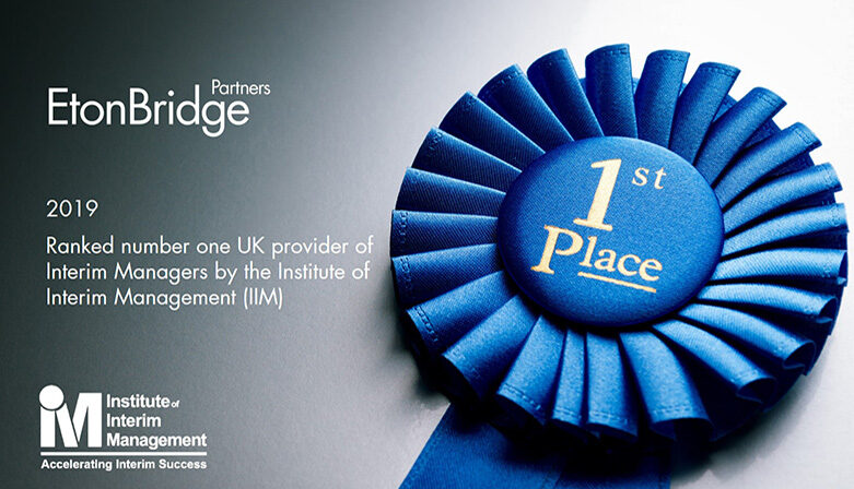 A Blue Ribbon Displays &Quot;1St Place&Quot; Beside The Etonbridge Partners Logo, Celebrating Their Win As The Top Uk Provider Of Interim Managers In The 2019 Iim Survey.