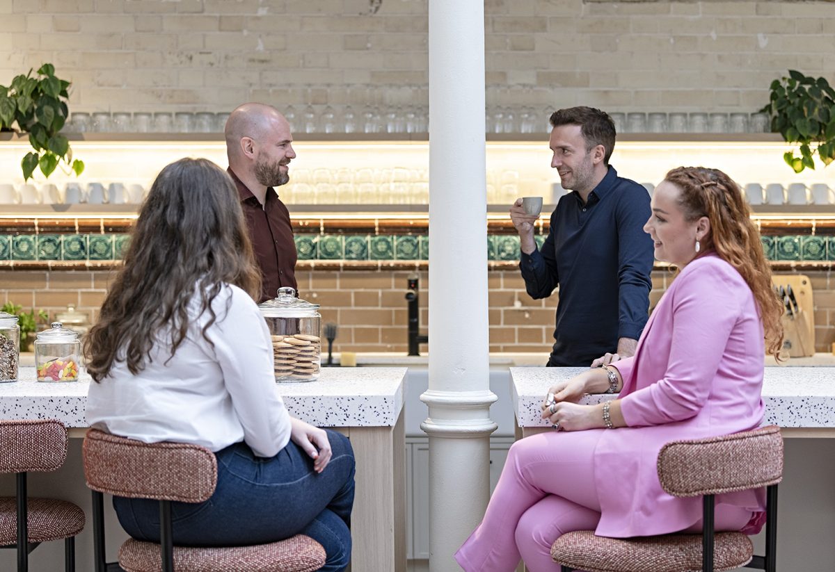 EBP employees in the London office kitchen, have a chat over a coffee