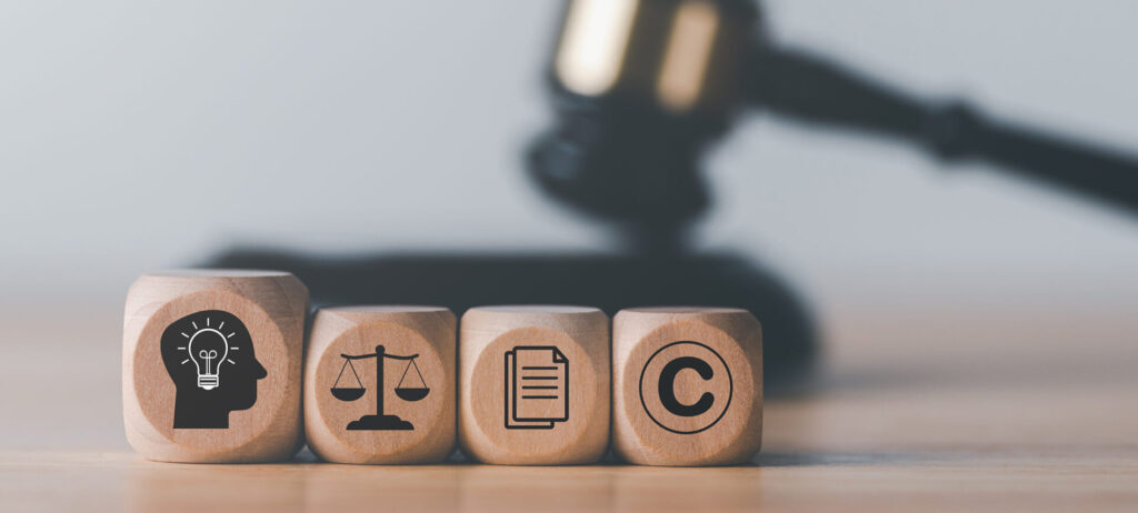 wooden blocks and Wooden judge gavel on the table, concept of copyright or intellectual property patent protection of copyright infringement proprietary declaration Legitimate innovations